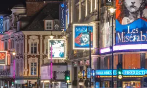 Tętniący życiem west end nocą, z neonami teatrów Apollo, Gielgud i plakatami "Les Misérables" oraz "The Crucible".